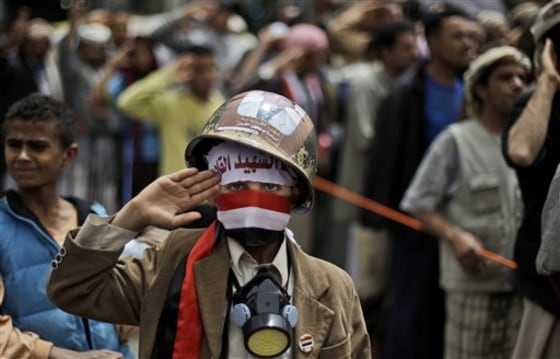 A Yemeni boy, wearing a helmet and a gas mask, salutes along with anti-government protesters during a demonstration demanding the resignation of Yemeni President Ali Abdullah Saleh, in Sanaa,Yemen, on Sunday.